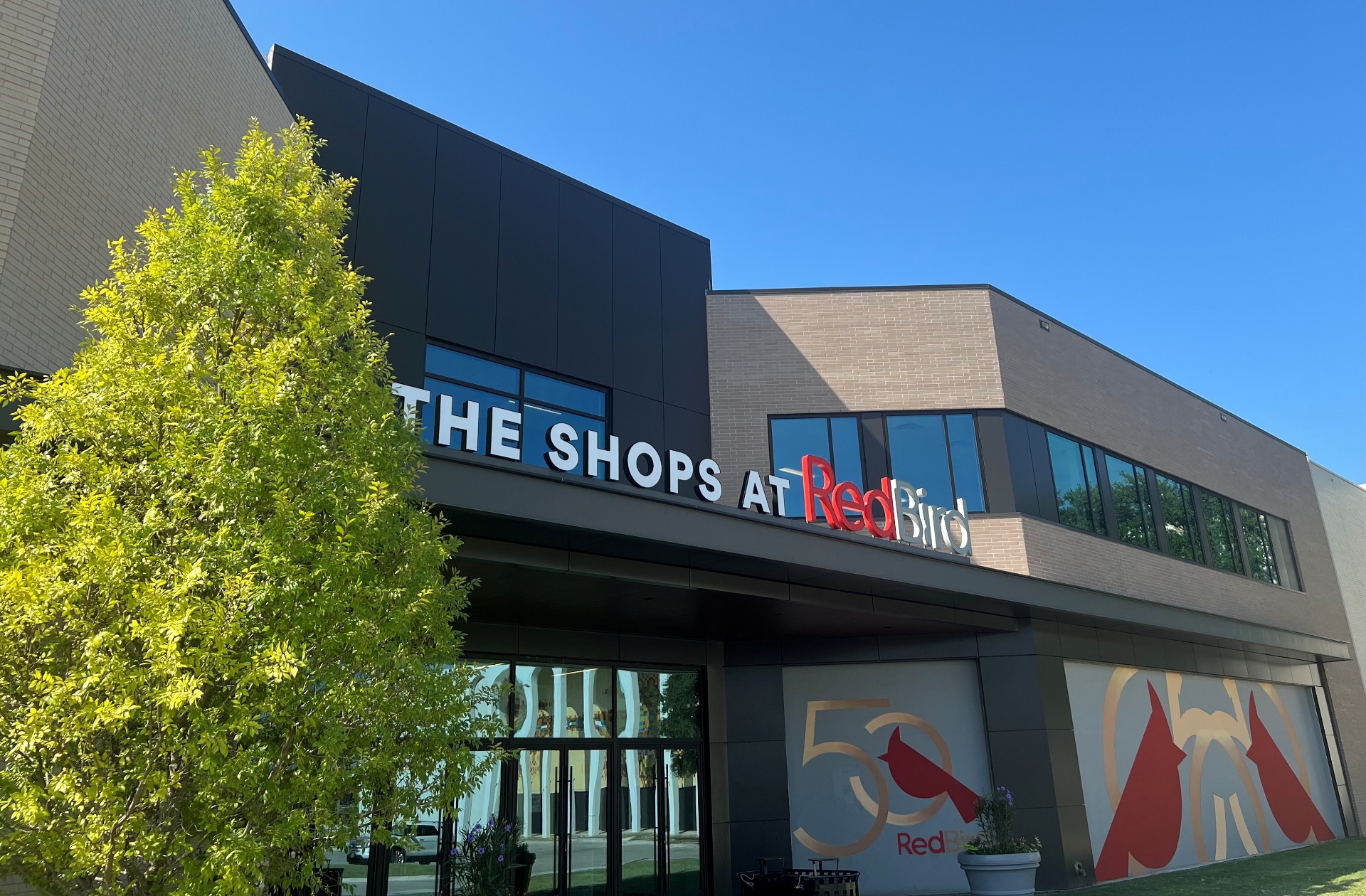 The Shops at RedBird mall entrance with 50th anniversary cardinal mural